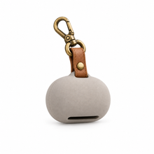 Pebble waste bag holder isolated on a clean white background